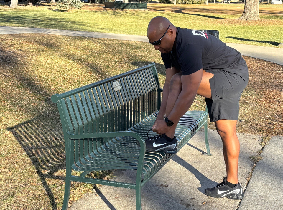 Eric lacing up shoes for a walk in the park